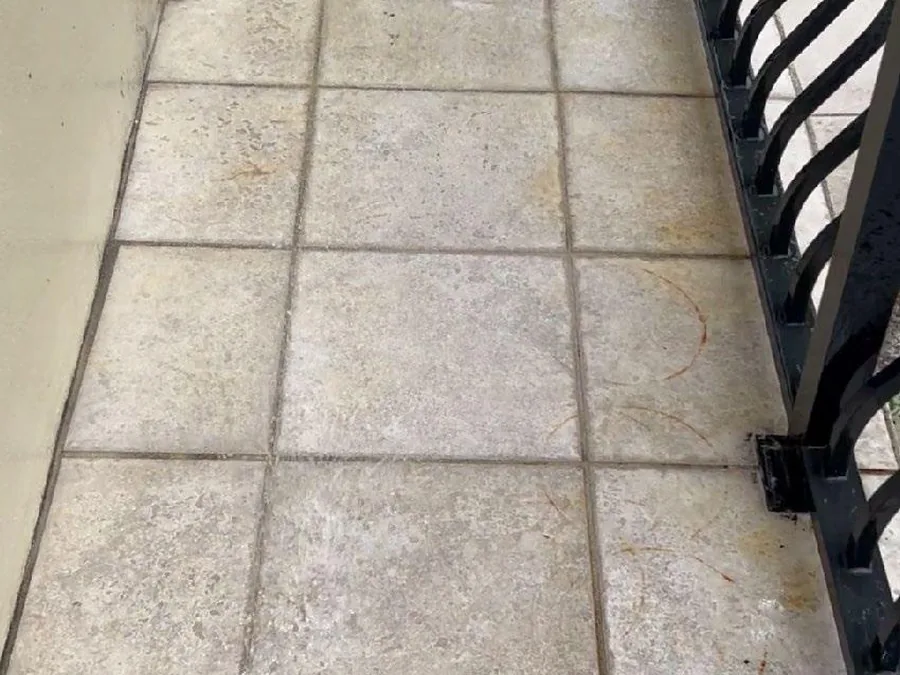 Tiled deck mid-pass, treated half cleared of grime