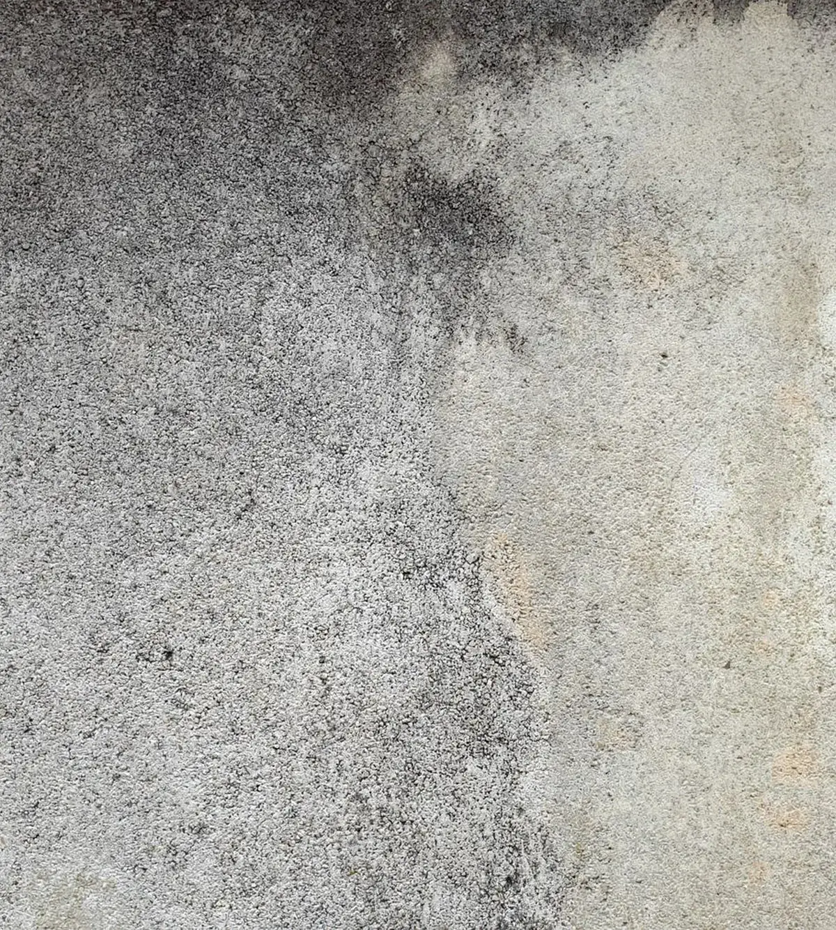 Concrete surface stained with grime and water marks